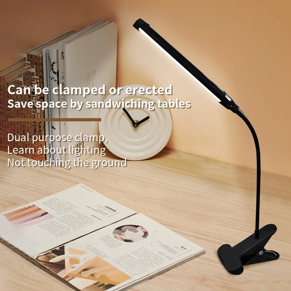 Vytra Clip Lamp clamped on desk reading book